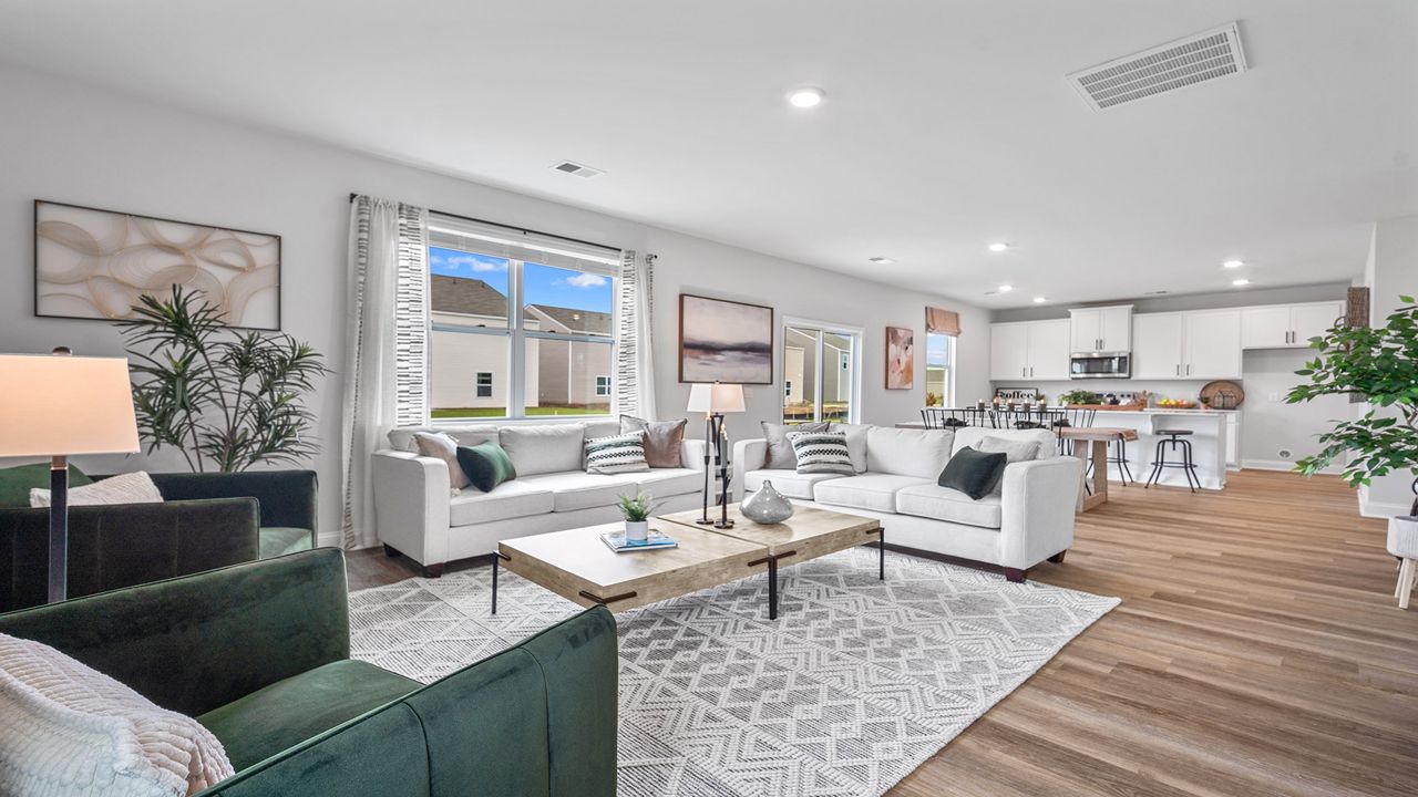 Living room of home with a couch, table, and chairs