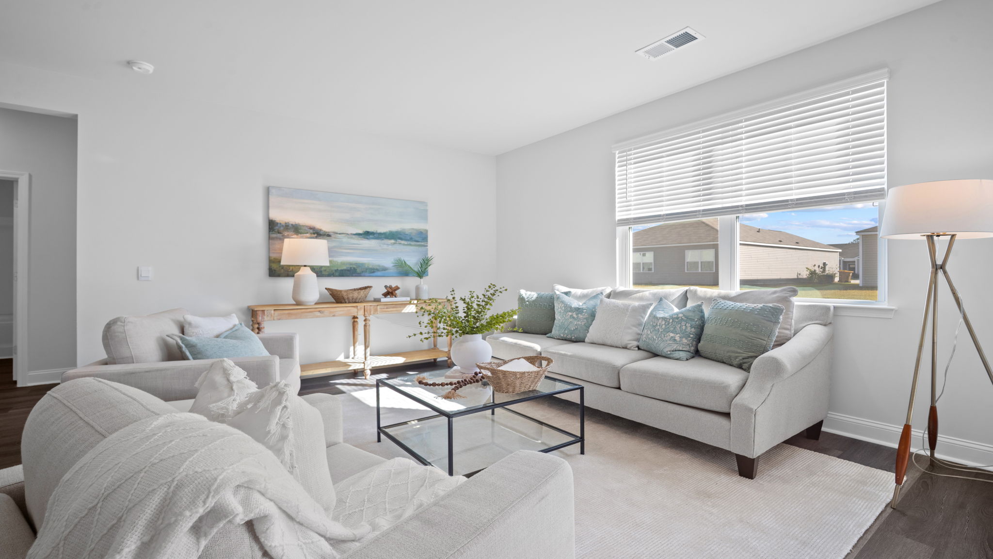 Living area decorated  with a couch, chairs and tables