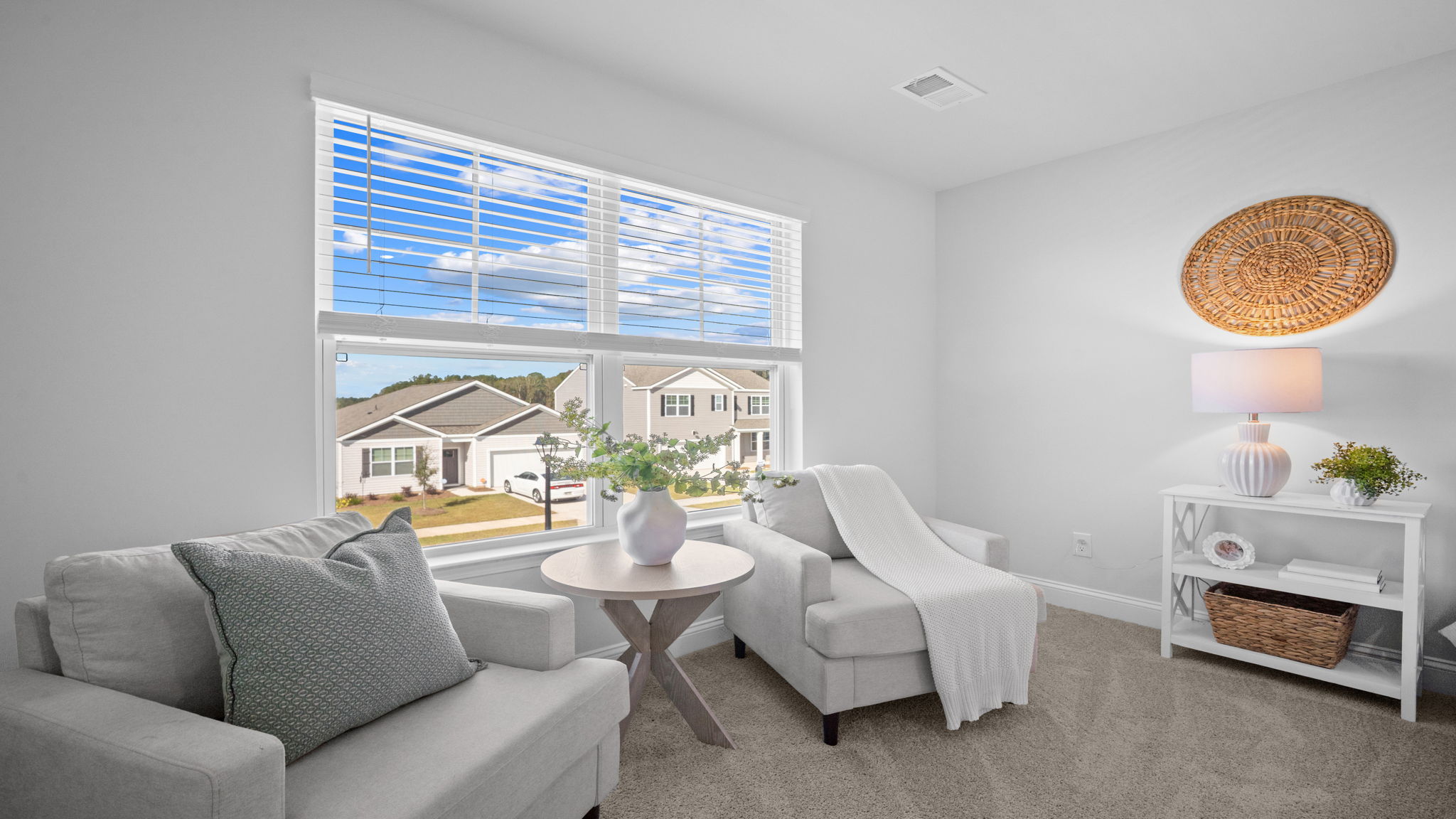 Primary bedroom with hardwood floors, large windows, and trey ceilings.