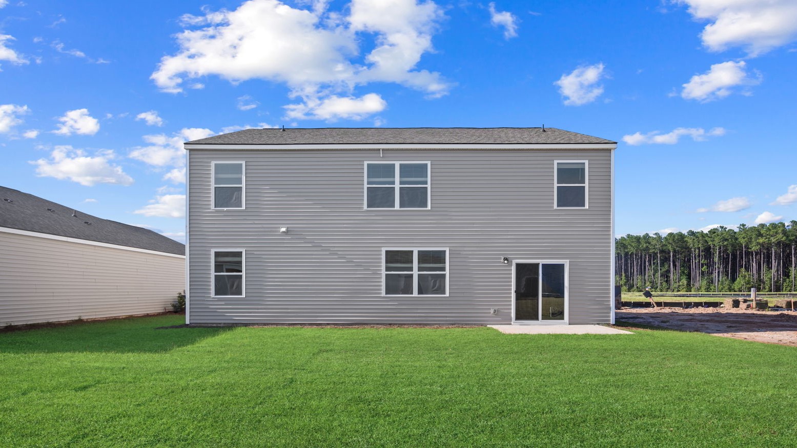 Back exterior of the covered patio opening up to the backyard.