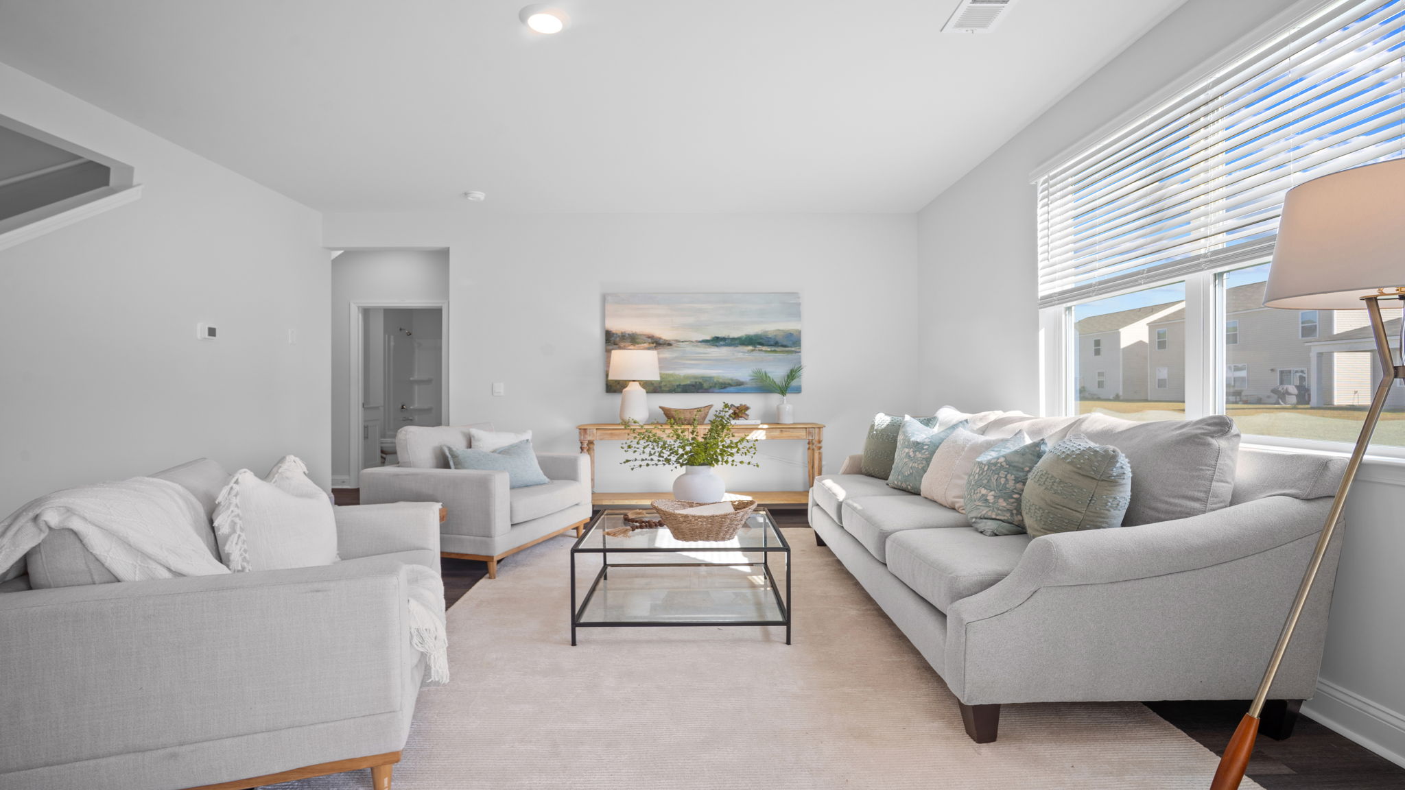 Living area with large windows for natural lighting.