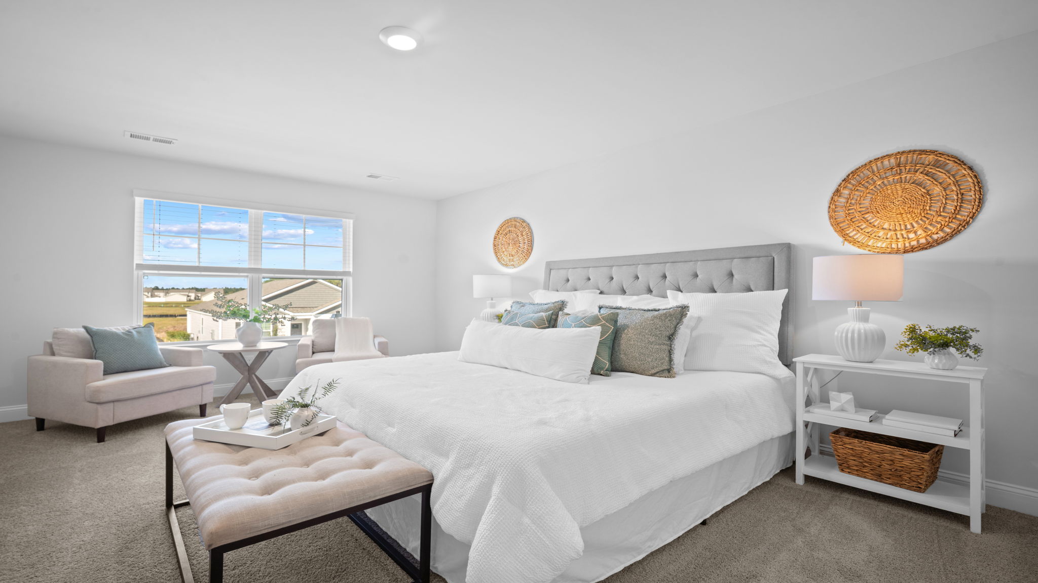 Primary Bedroom with a bed, dresser, and side table
