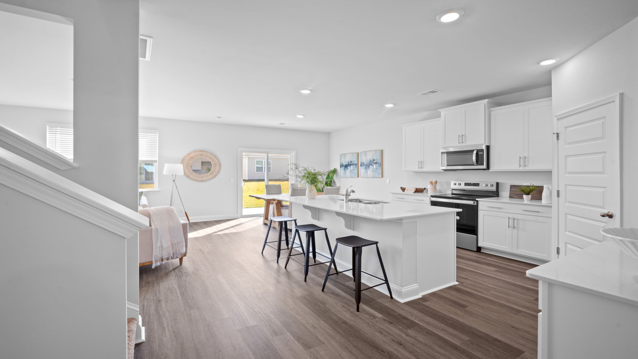 Kitchen island with bar seating and view of the oven range in the background