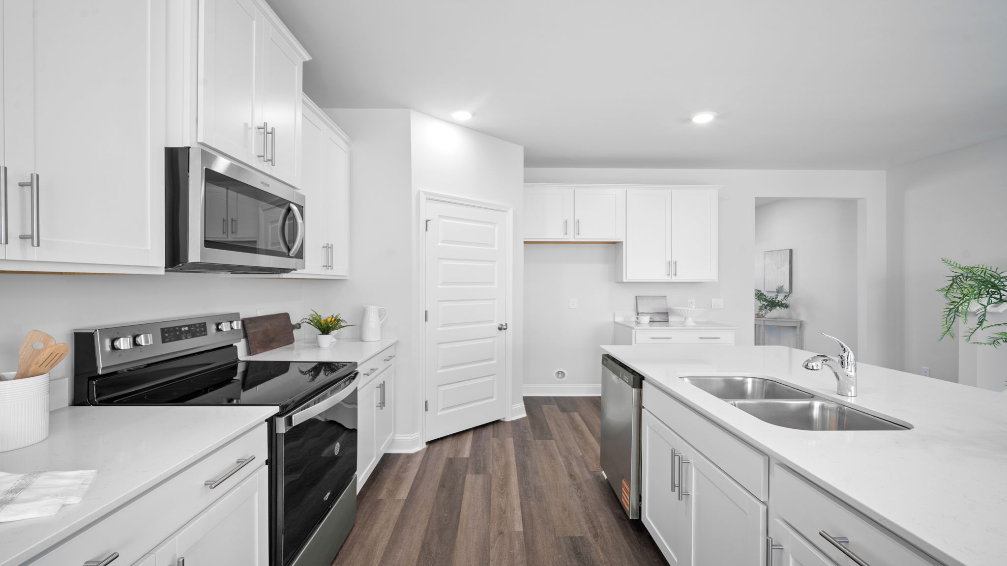 Kitchen island with bar seating and view of the oven range in the background