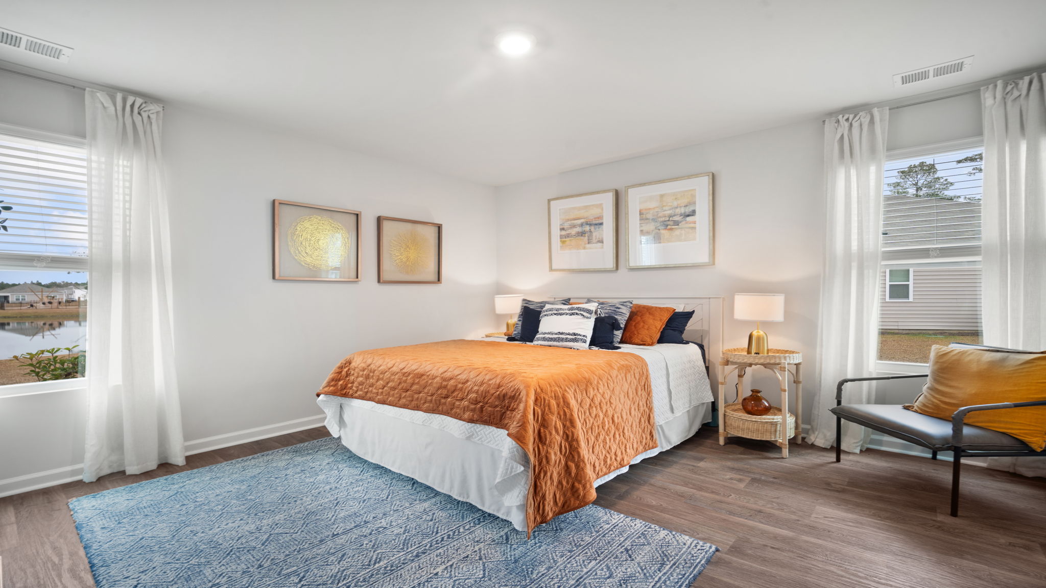 Primary bedroom with a bed and side table