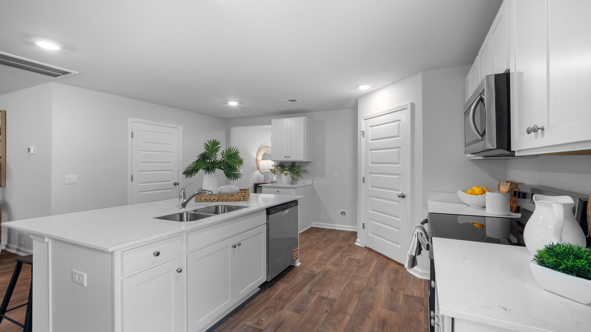 Kitchen walkway with counters on both sides