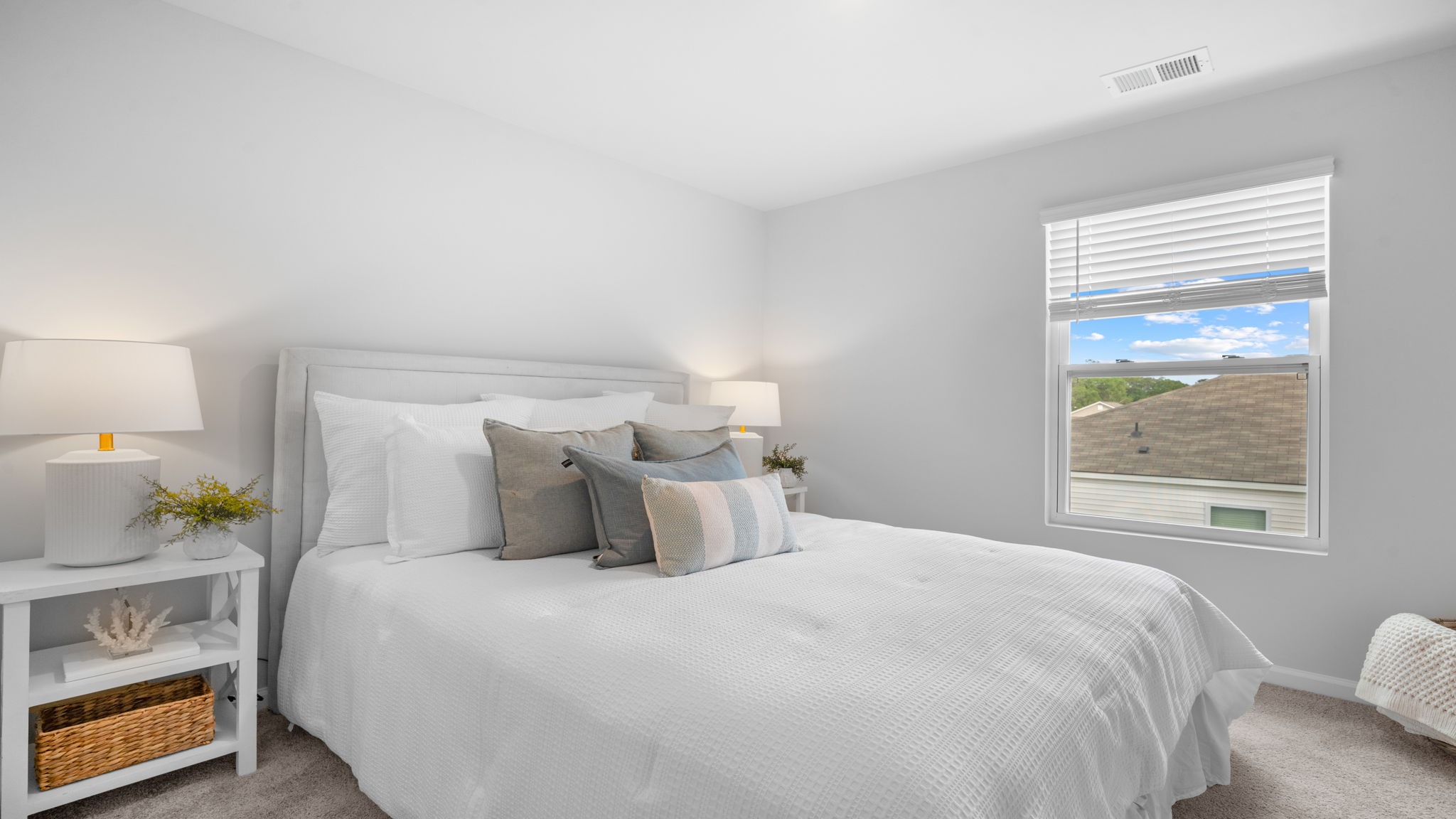 Primary bedroom decorated with a bed and a side table