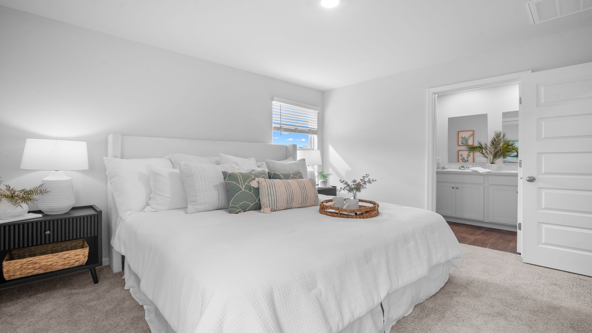 Primary bedroom decorated with a bed and a side table