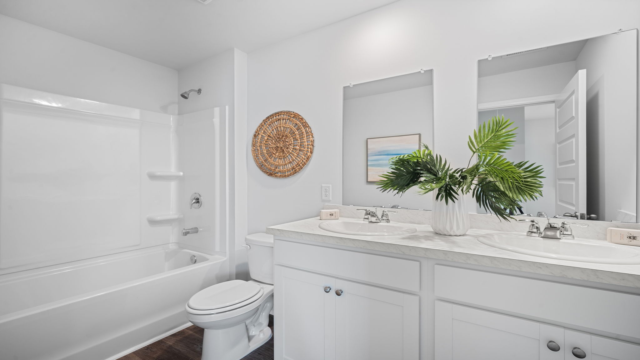 Bathroom with single sink vanity, with shower and tub combination and built in shelving.
