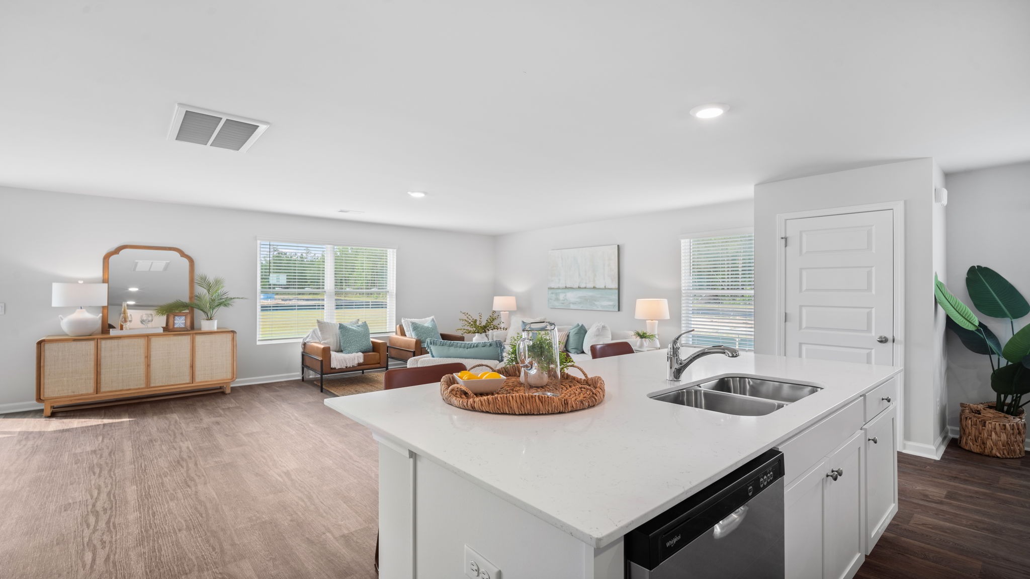Open concept kitchen with view behind the island with living area.