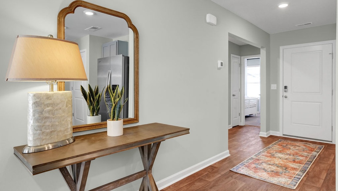 Welcoming foyer in the Macon floor plan by D.R. Horton featuring an inviting entryway and access to the home's open-concept living spaces.