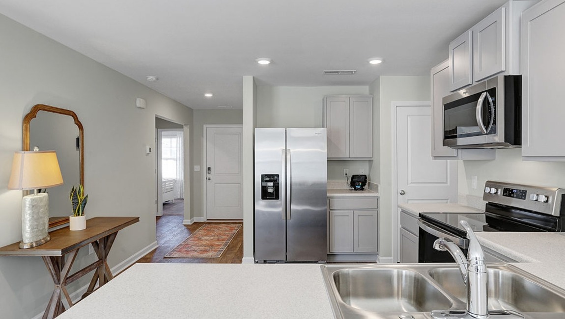 "Bright kitchen in the Macon floor plan with contemporary cabinetry, modern appliances, and a functional layout designed for entertaining."