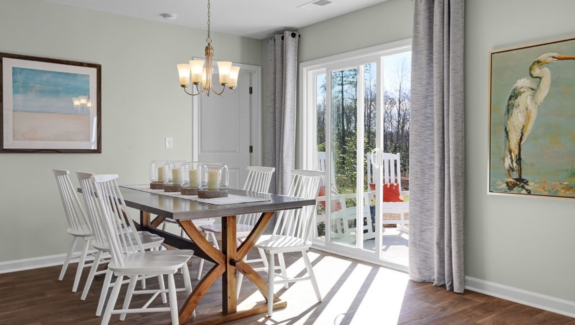 "Elegant dining area in the Macon floor plan by D.R. Horton featuring open-concept living, natural light, and space for family gatherings."