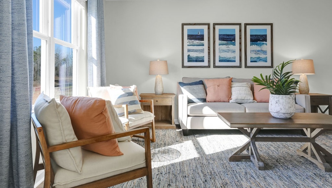 "Large family room in the Macon home showcasing open-concept living and direct access to the kitchen and dining area."