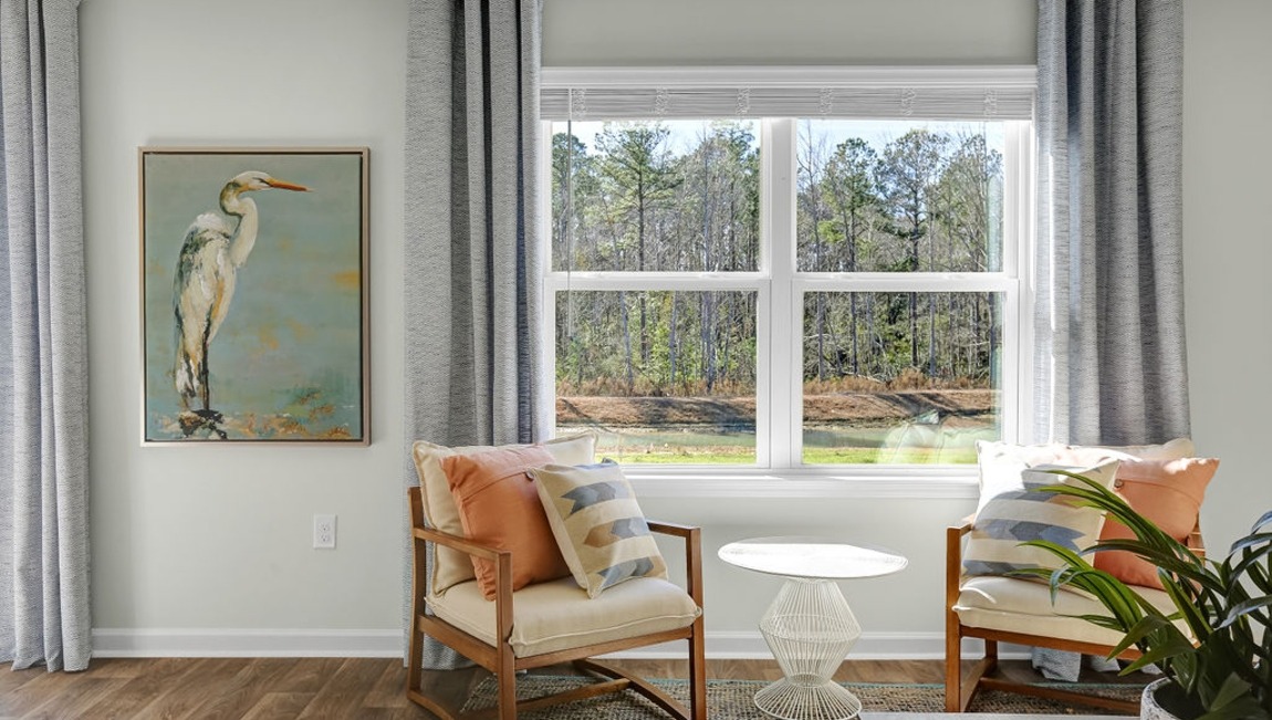 "Large family room in the Macon home showcasing open-concept living and direct access to the kitchen and dining area."