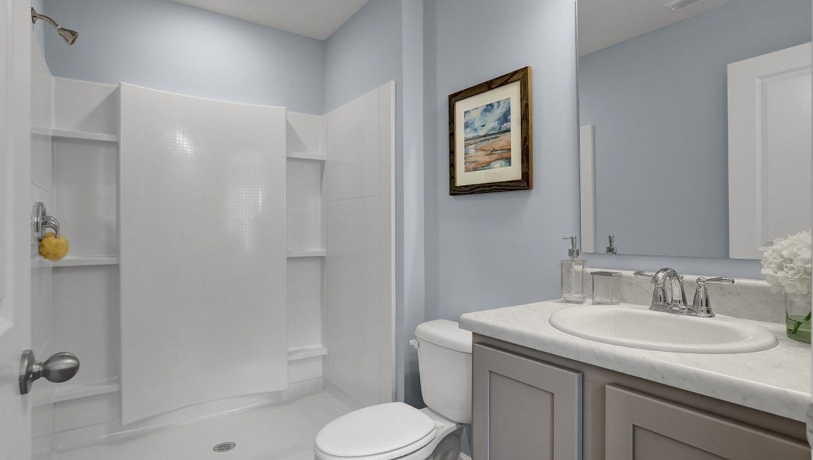 "Spa-inspired primary bathroom in the Macon floor plan by D.R. Horton featuring dual vanities, modern fixtures, and elegant finishes."