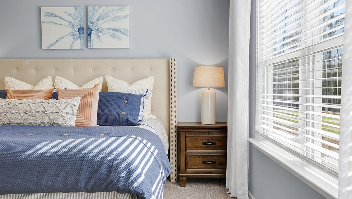 Primary bedroom with a bed and side table