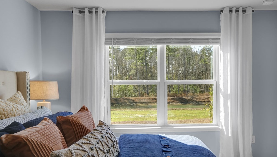 Primary bedroom with a bed and side table