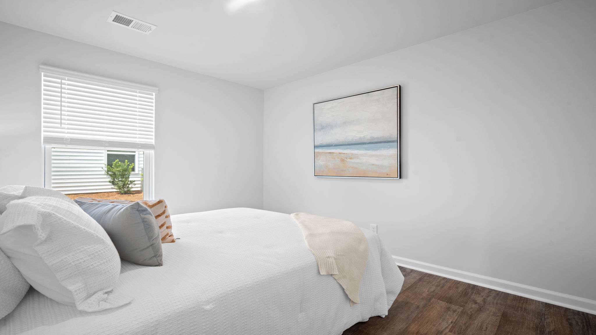 Guest bedroom decorated with a bed and side table