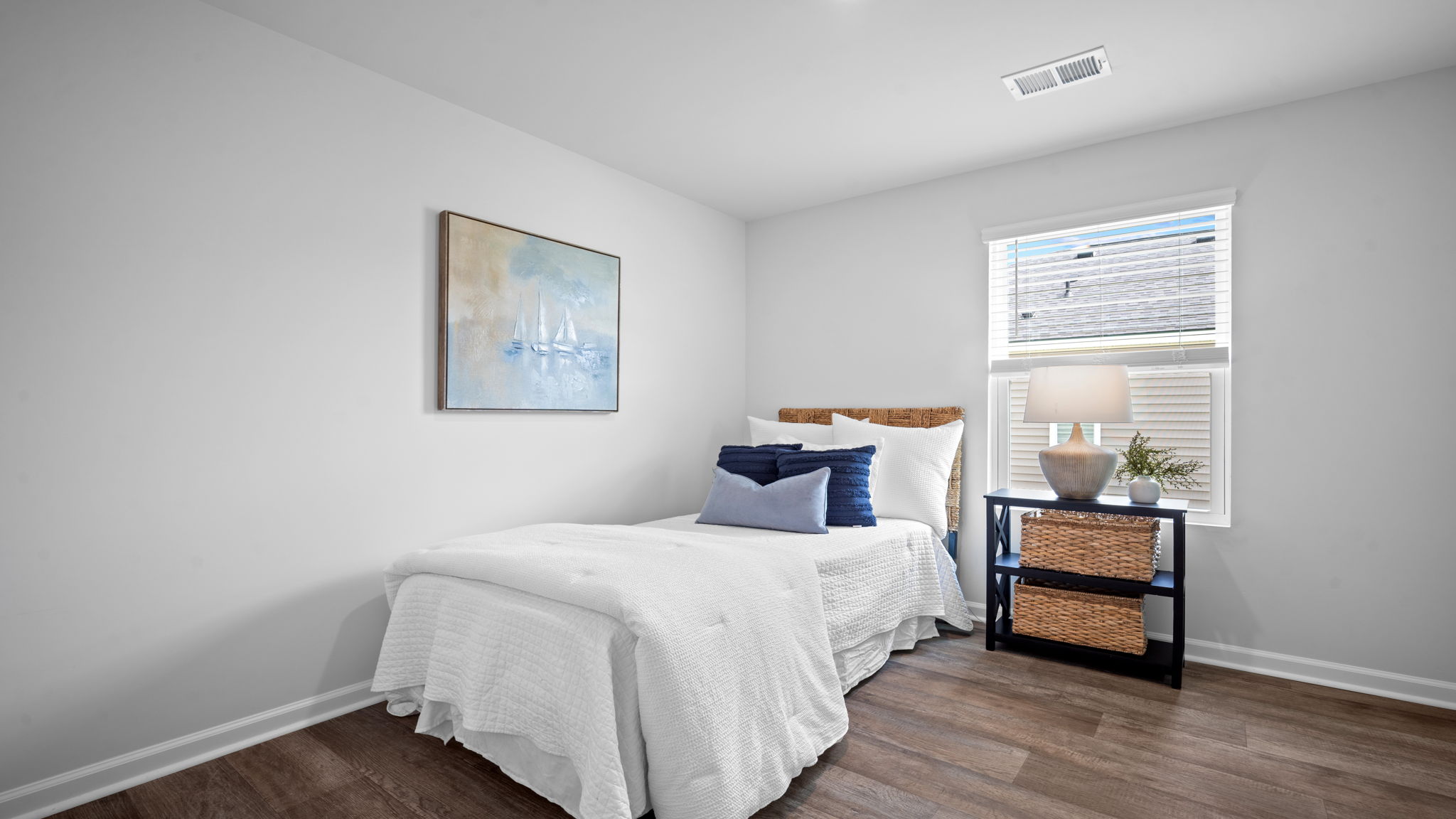 Guest bedroom with a bed and side table