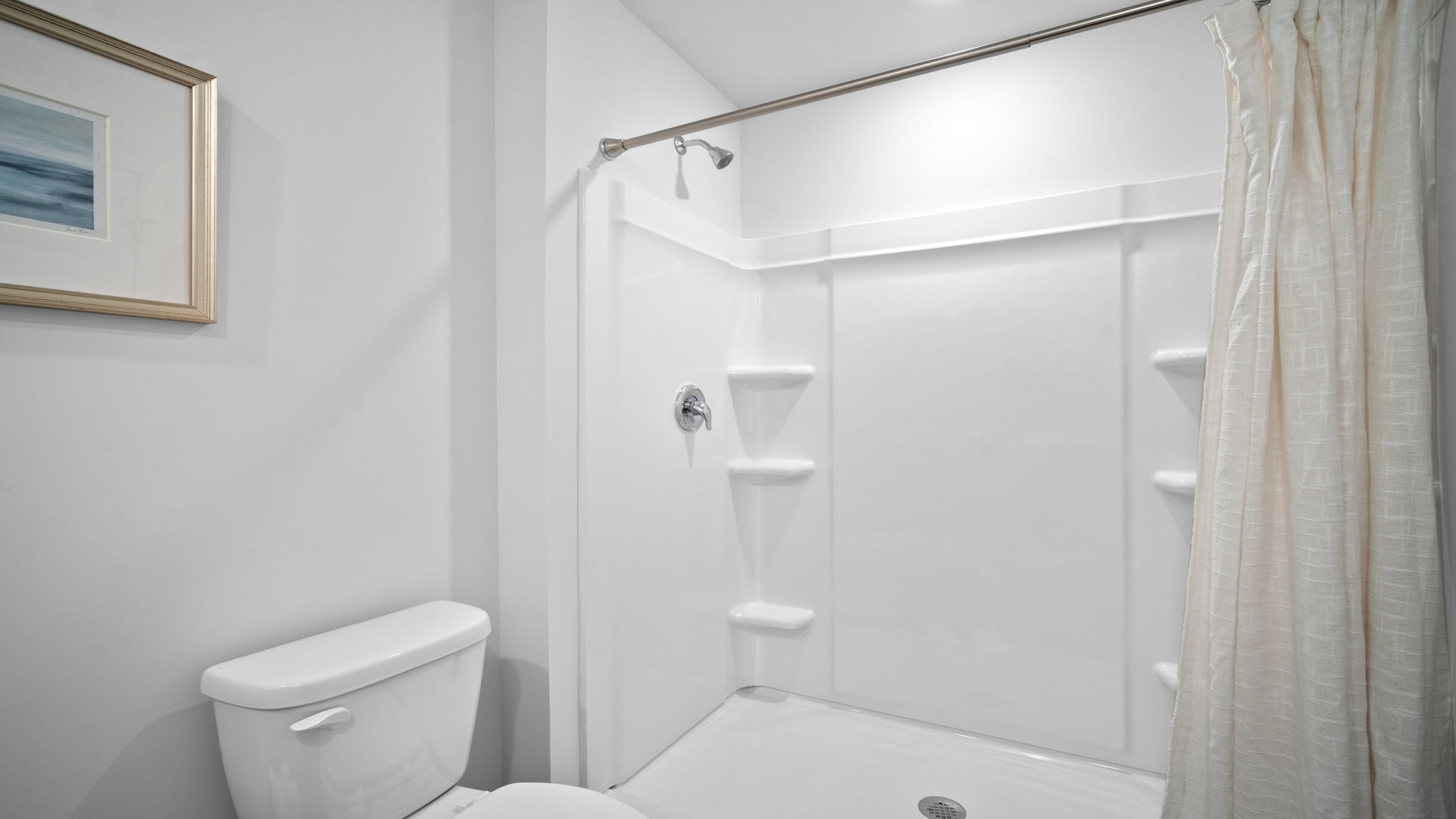 Owner's bathroom in the Freeport by D.R. Horton featuring dual vanities, walk-in shower, contemporary fixtures, and spacious layout.