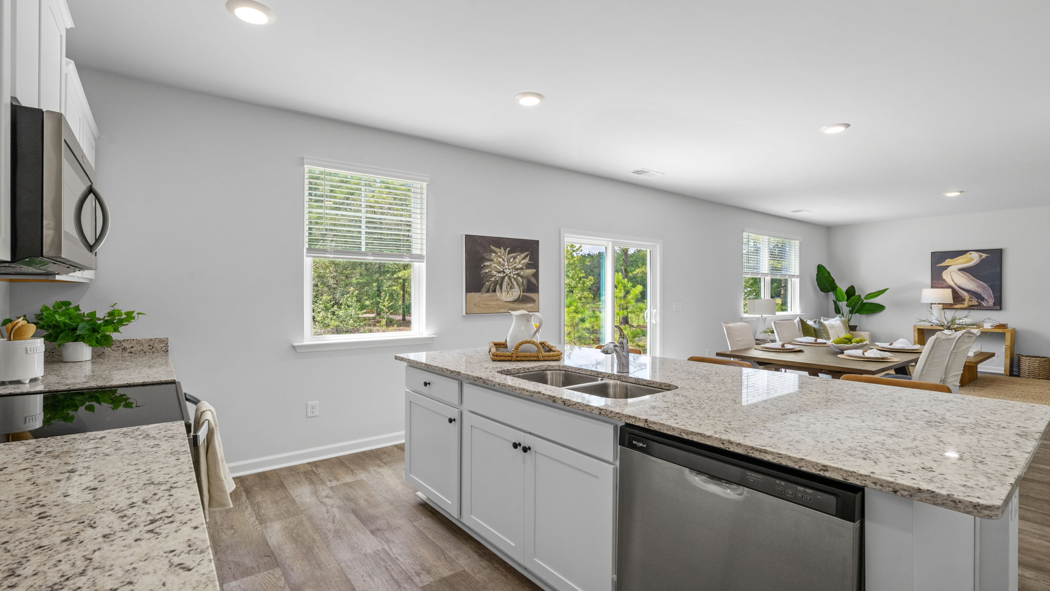 Gourmet kitchen in the Belhaven floorplan at Holly Oaks featuring designer-inspired finishes, a large center island, abundant storage, energy-efficient stainless steel appliances, and an open layout ideal for modern family living.