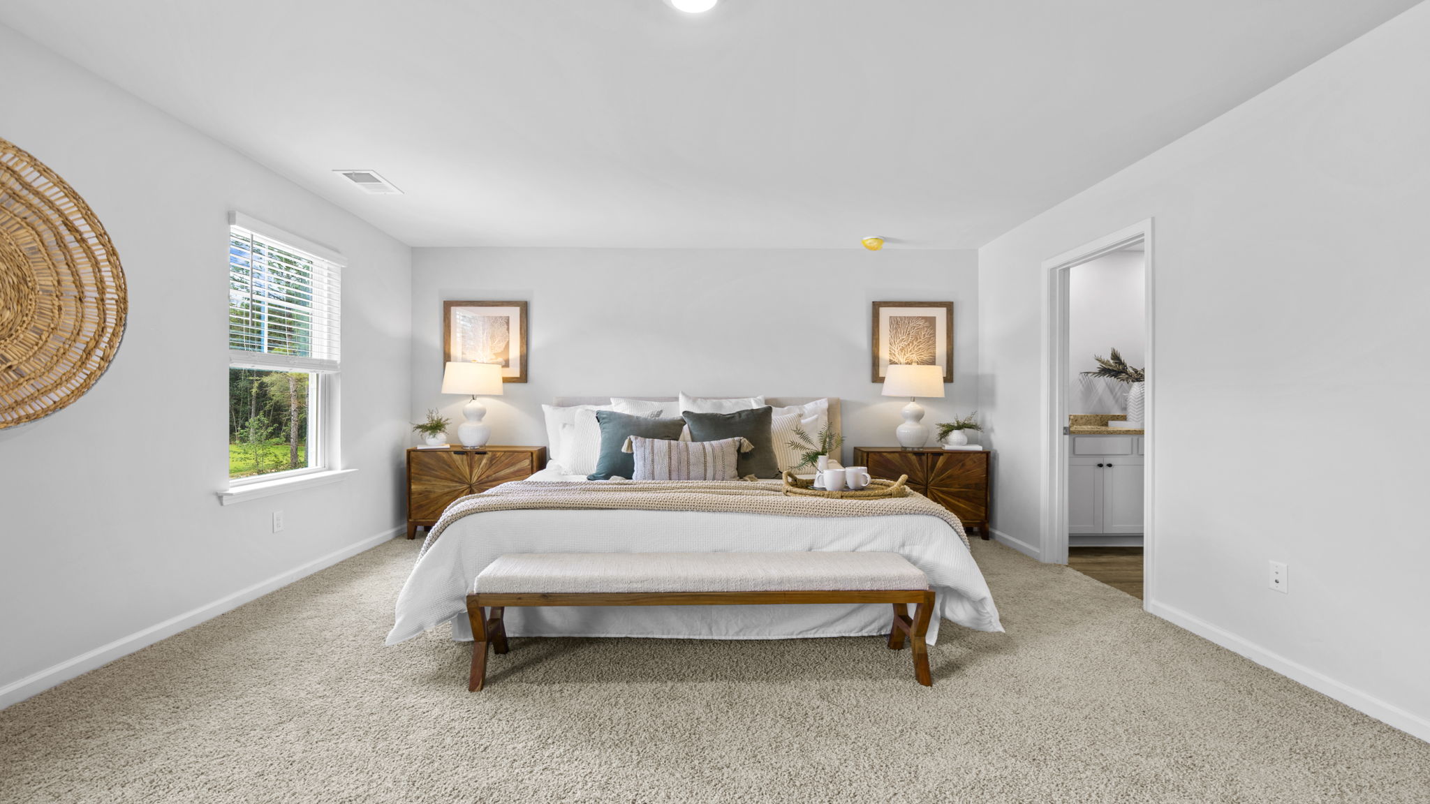 Owner's suite in the Belhaven by D.R. Horton showcasing generous square footage, abundant natural light, and convenient access to a luxurious ensuite bathroom.