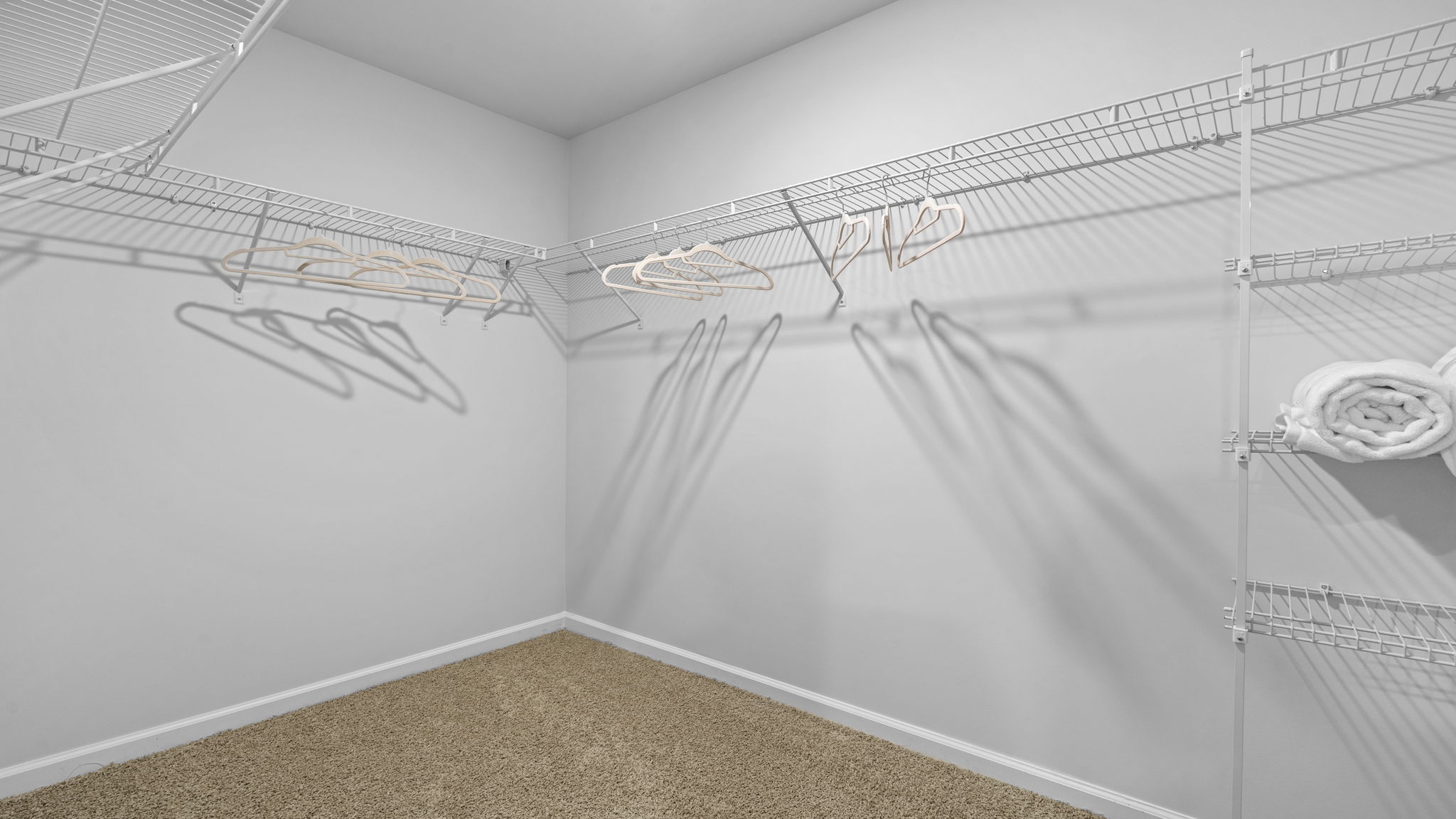 Large walk-in closet in the Belhaven floorplan featuring generous storage space, organization options, and convenient access from the primary bedroom suite.