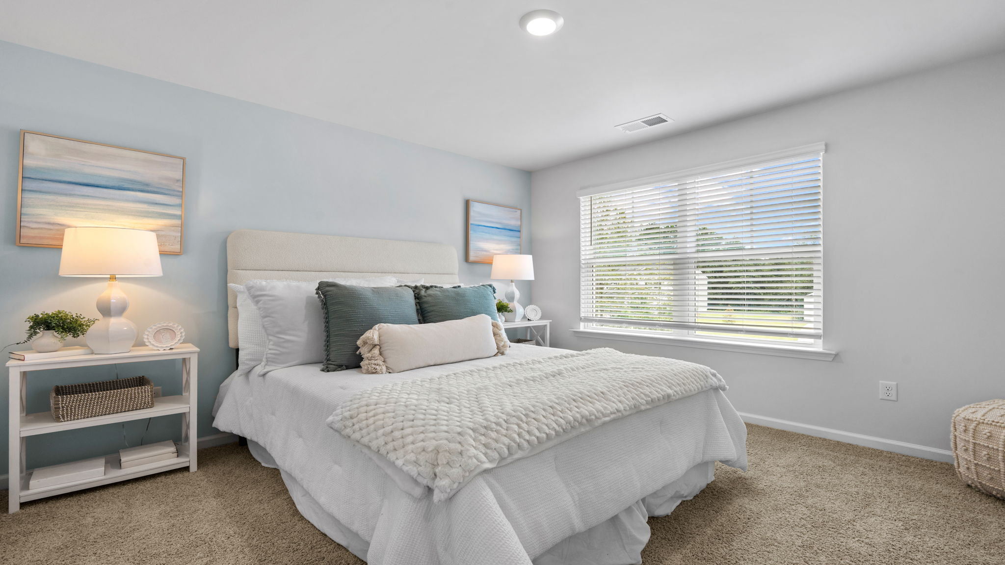 Comfortable secondary bedroom in the Belhaven floorplan at Holly Oaks featuring abundant natural light, closet storage, and versatile space for family members or guests.
