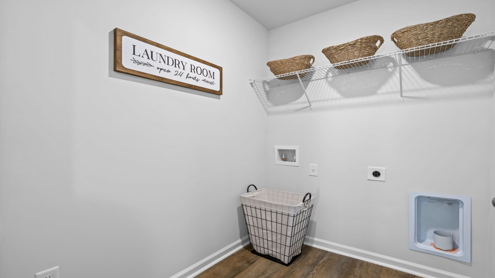 Dedicated laundry room in the Belhaven floorplan at Holly Oaks featuring functional workspace, appliance connections, and room for additional storage solutions.