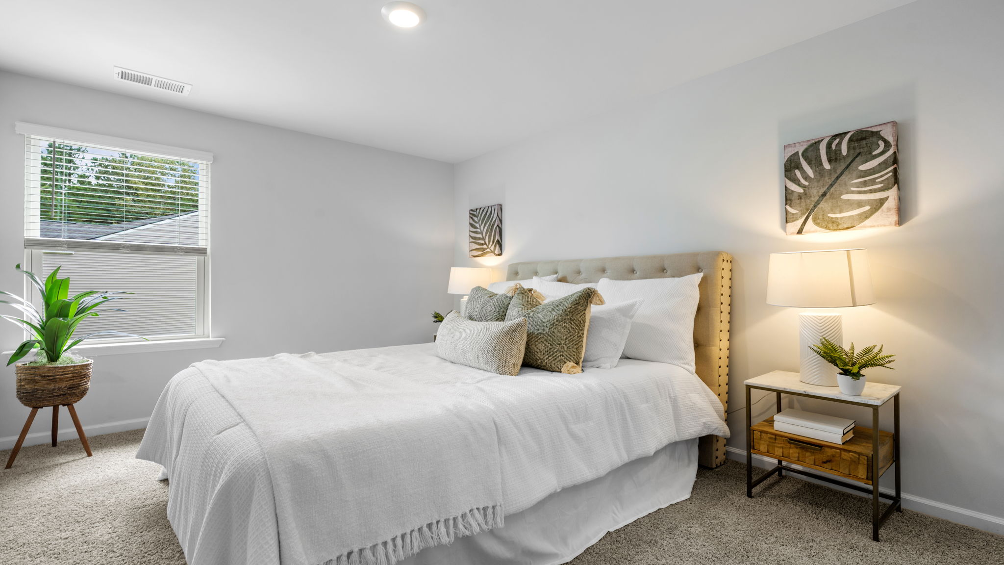 Inviting guest bedroom in the Belhaven floorplan at Holly Oaks by D.R. Horton featuring abundant natural light, spacious closet storage, modern finishes, and versatile space ideal for overnight guests, family members, or a home office.