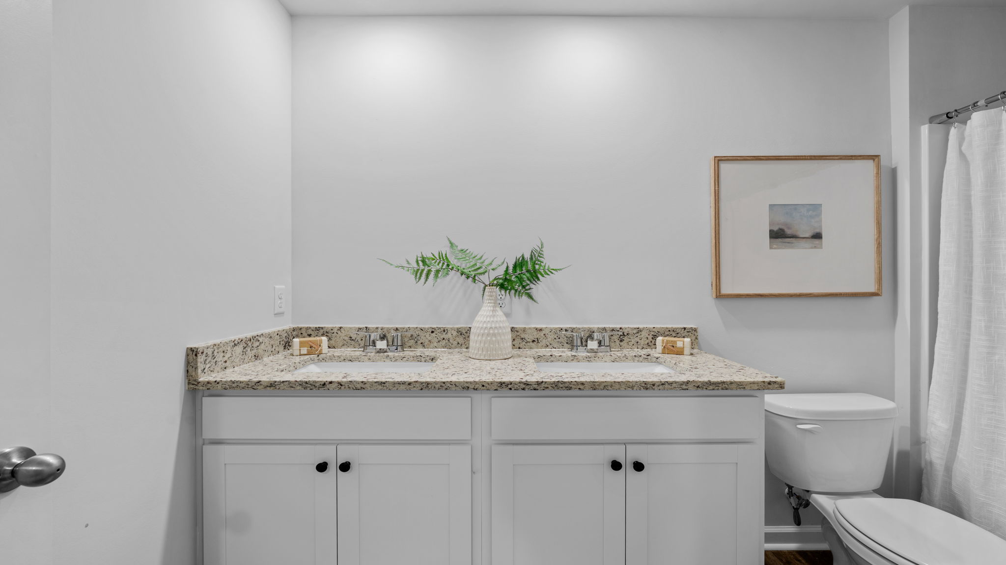 Stylish guest bathroom in the Belhaven floorplan featuring modern fixtures, vanity storage, and convenient access for family members and visitors.