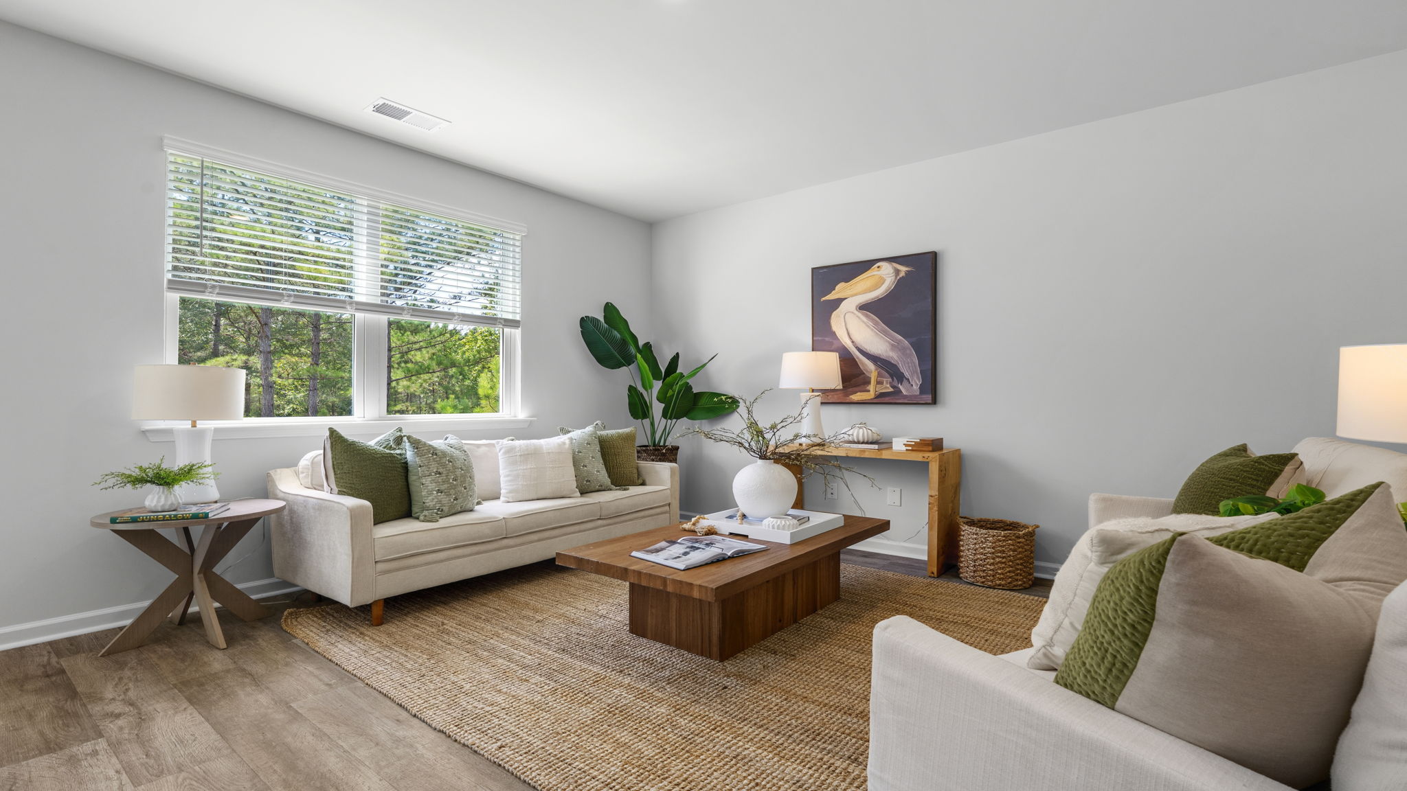 Spacious great room in the Belhaven floorplan at Holly Oaks featuring abundant natural light, open-concept design, modern finishes, and flexible living space for relaxing and entertaining.