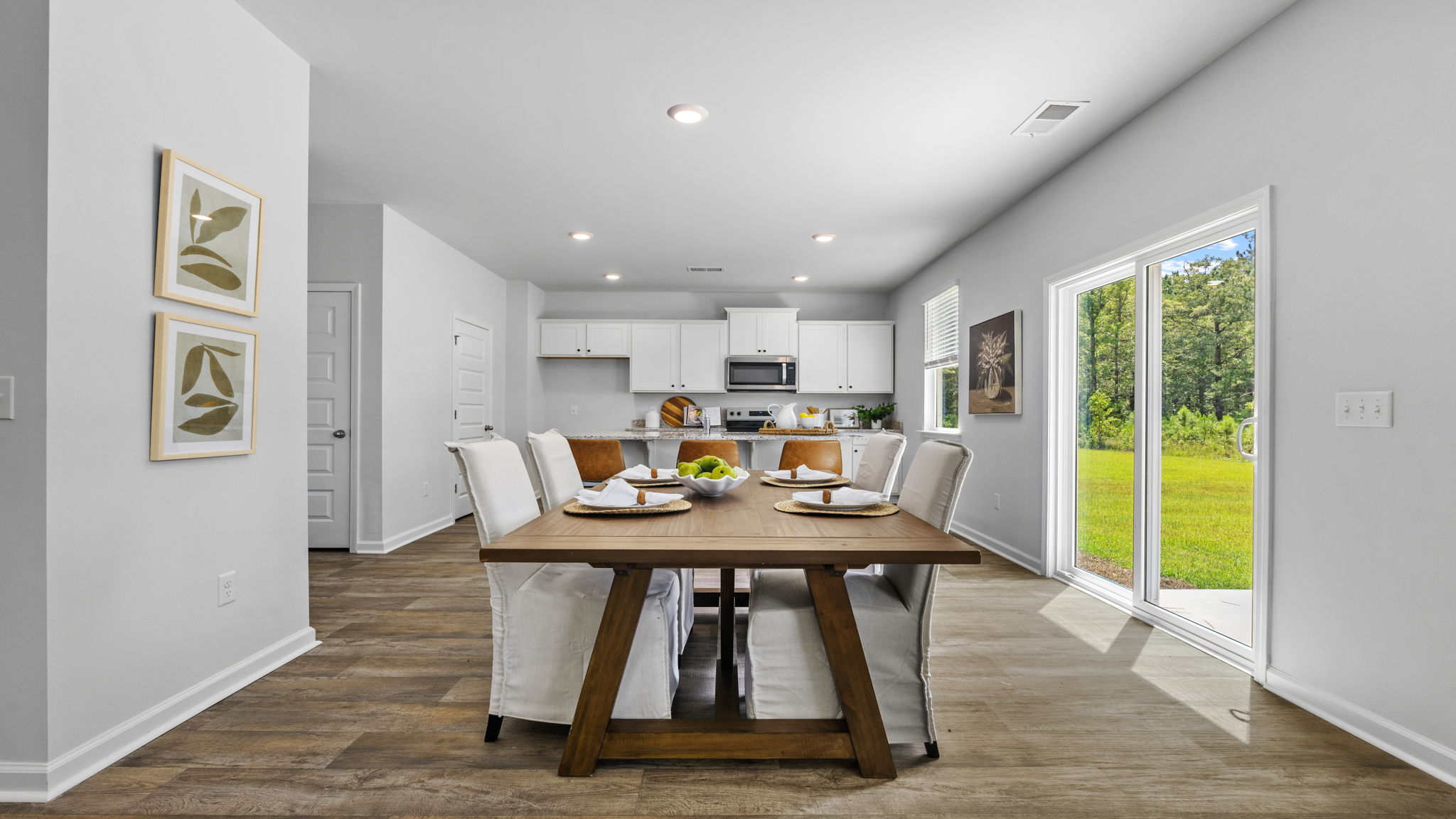 Elegant dining area in the Belhaven floorplan at Holly Oaks featuring open sightlines, natural light, and convenient access to the kitchen for effortless entertaining.
