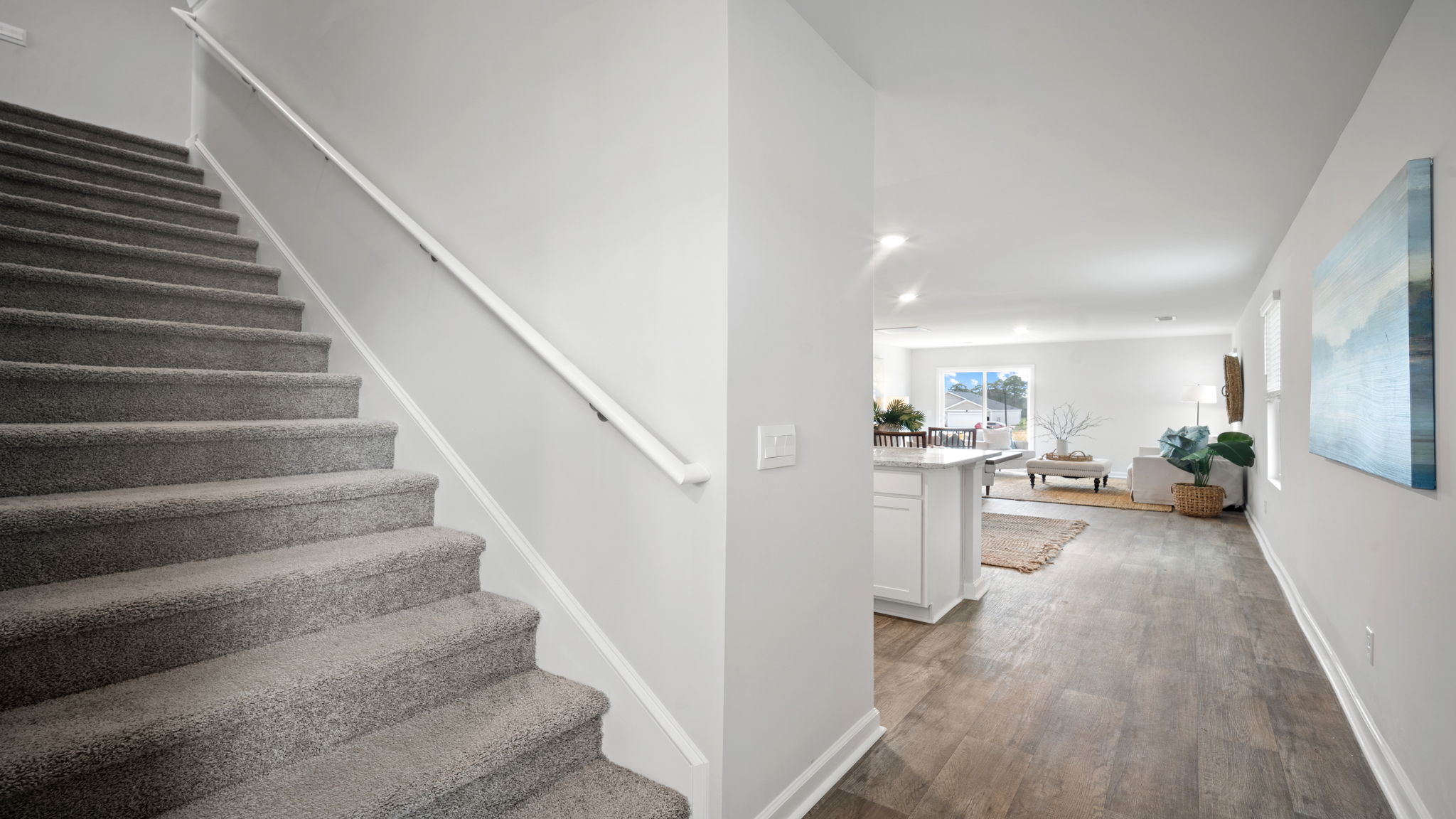 Staircase with living area behind