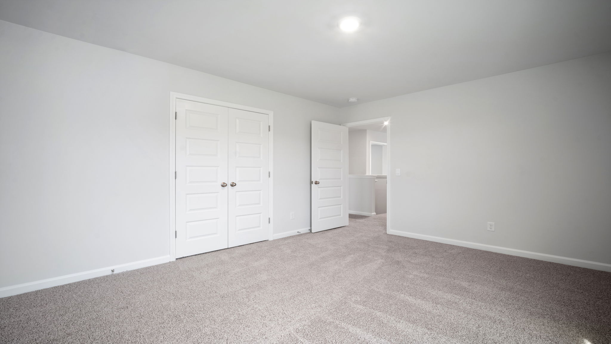 Bedroom with closet door and entry door.