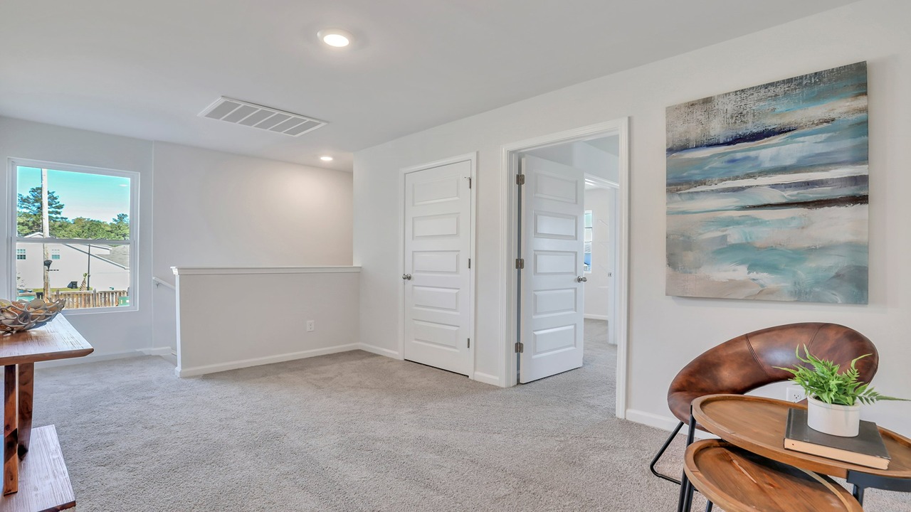 Upstairs loft with a table and chair