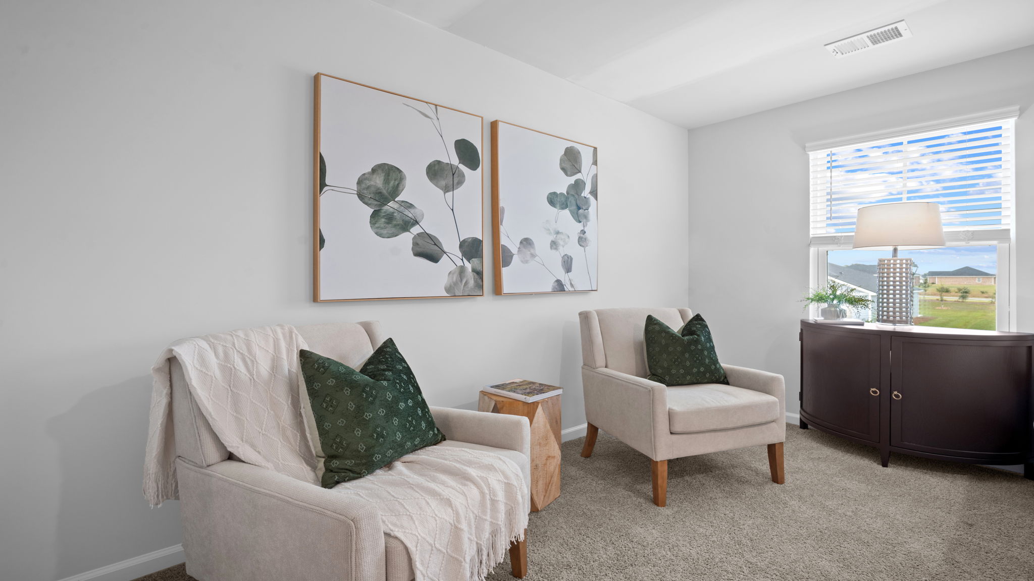 Primary bedroom with carpeted floors, large windows, and trey ceilings.