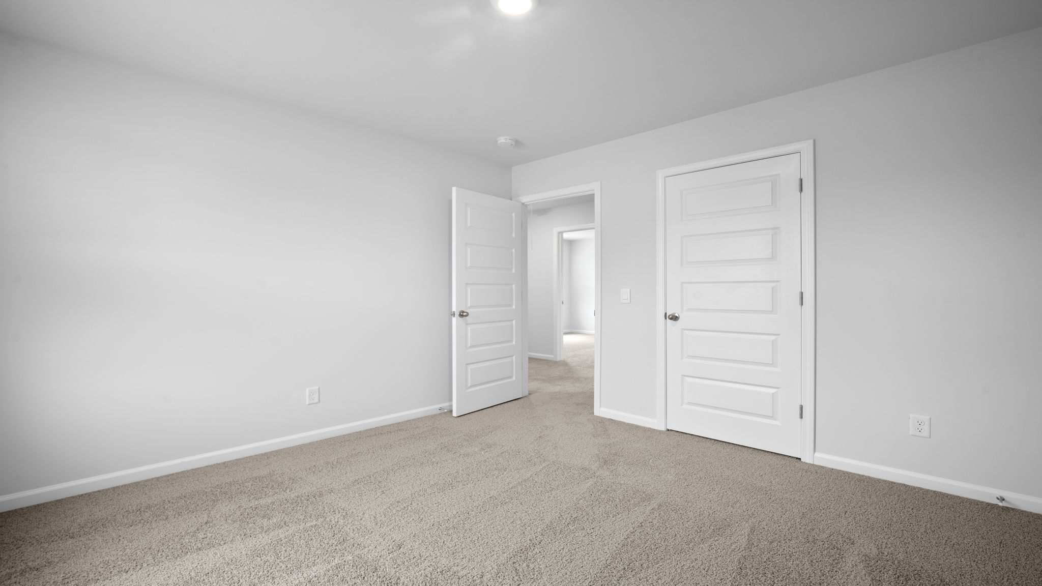 Bedroom with closet door and entry door.