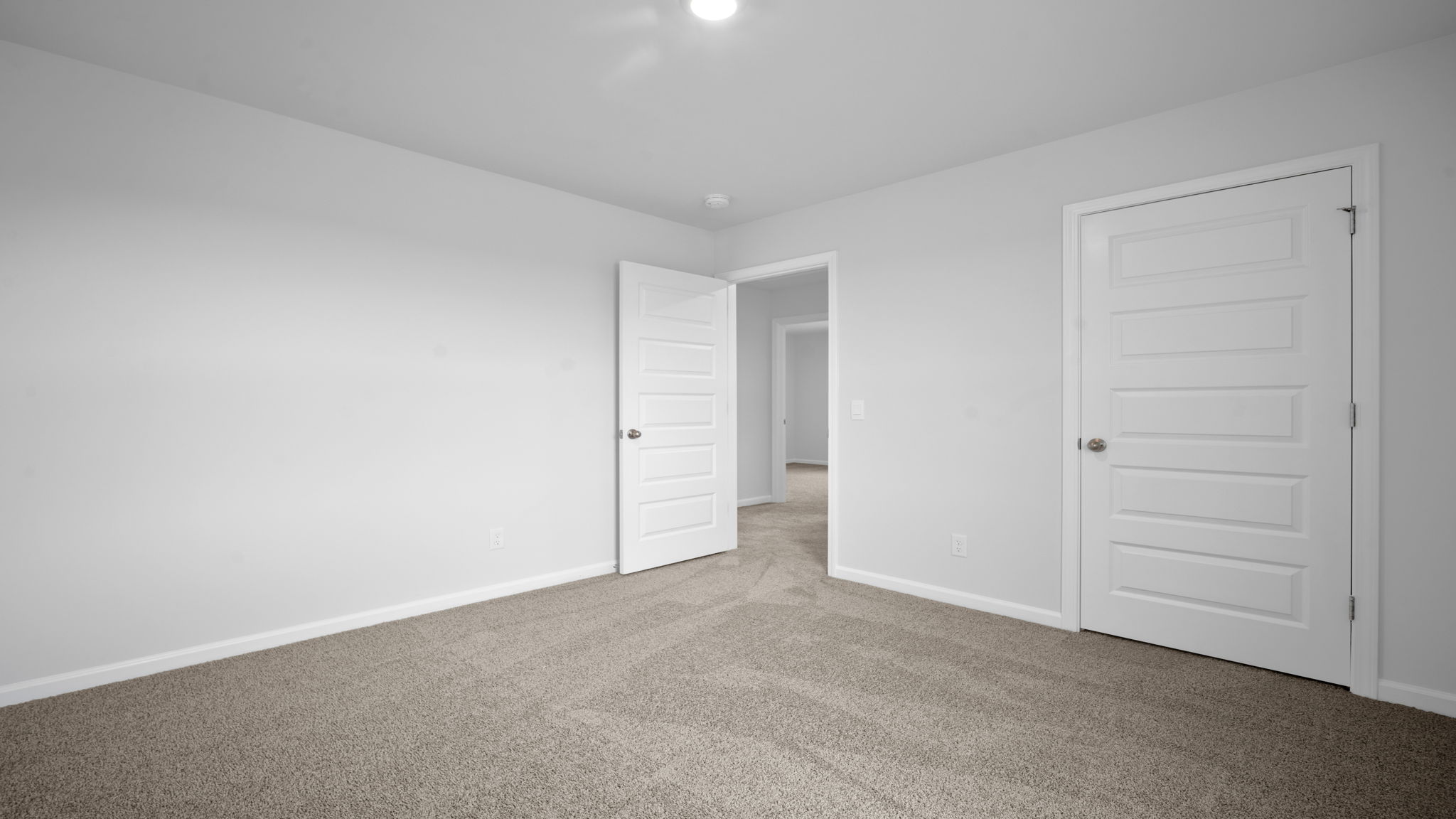 Bedroom with closet door and entry door.