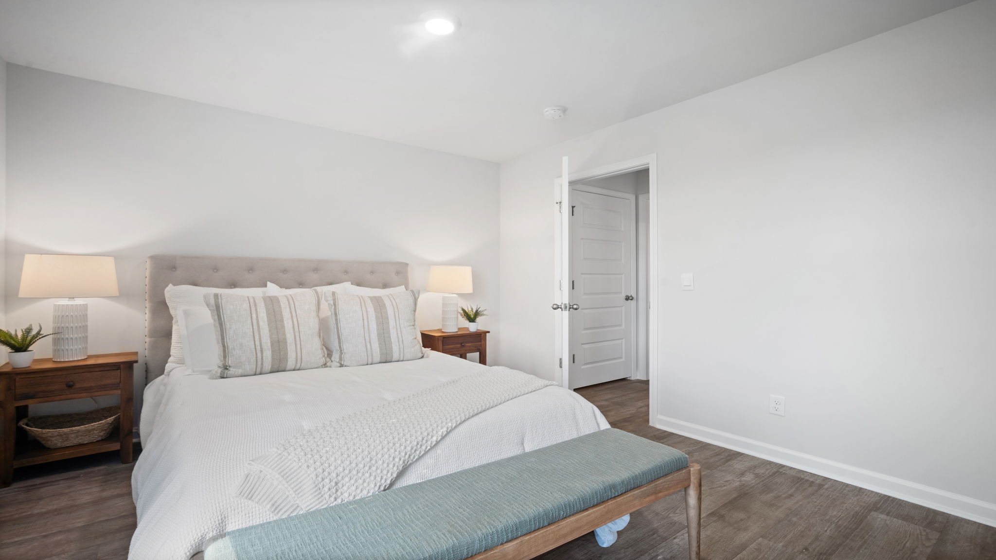 Guest bedroom decorated with a bed and side table