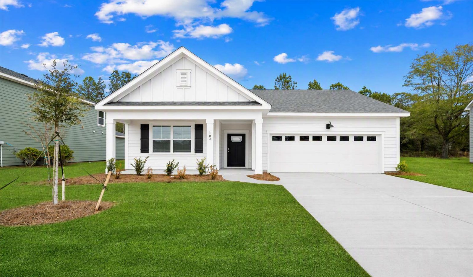 Cali S Front of home Laurel Grove white exterior green grass