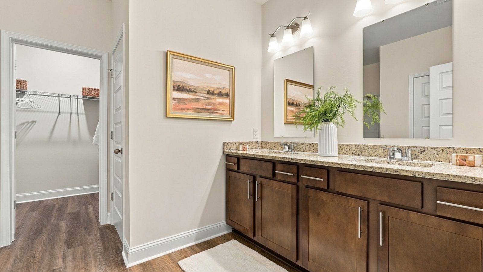 Primary bathroom with dual vanity, modern finishes, and ample storage in the owner's suite.