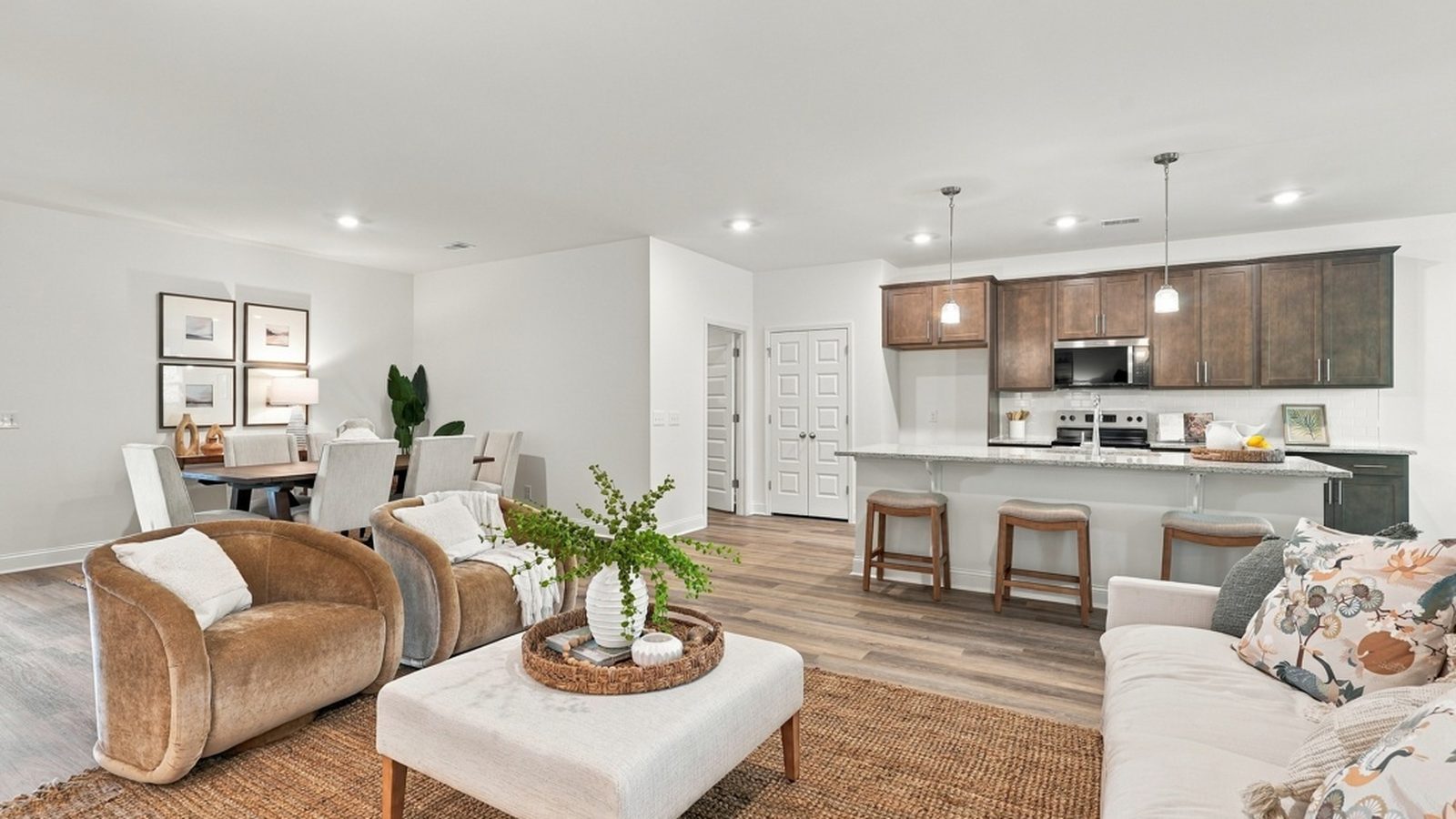 Bright open-concept living room and kitchen with abundant natural light, ideal for entertaining and everyday living.
