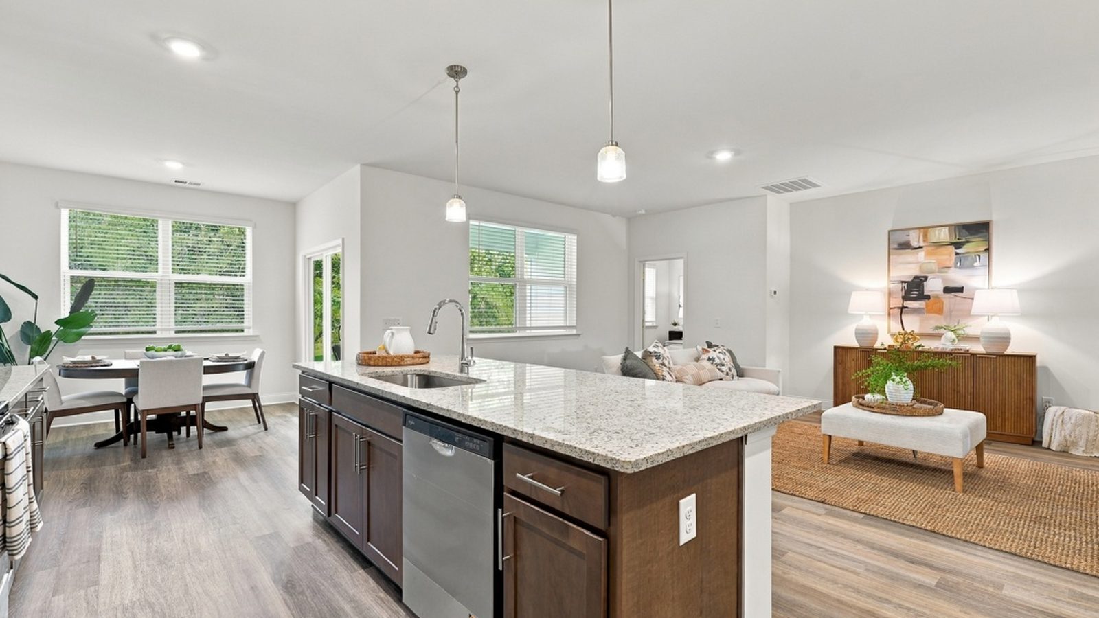 Open-concept kitchen, dining area, and living room creating a functional layout for gathering and entertaining.