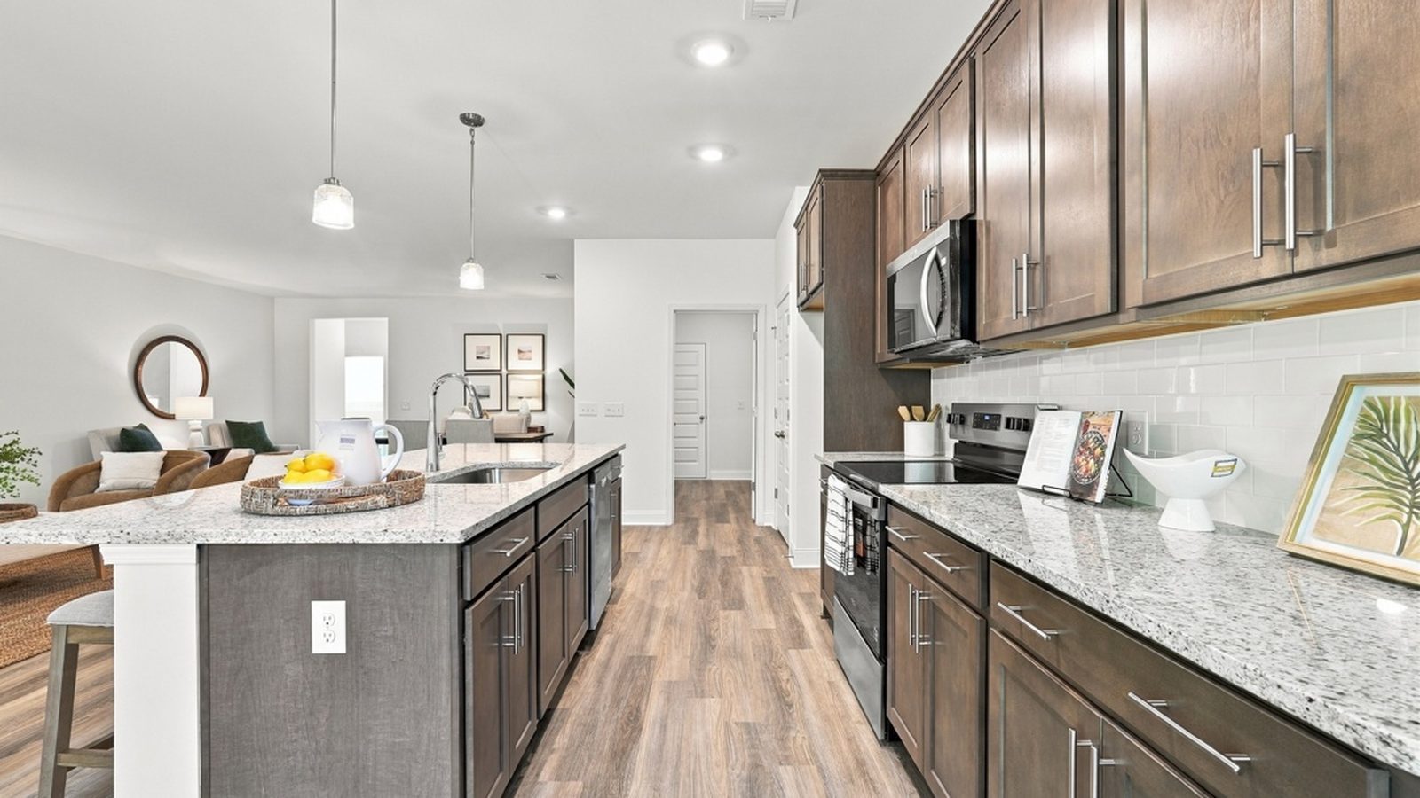 Side view of the designer kitchen highlighting extensive counter space, stylish cabinetry, and contemporary finishes.