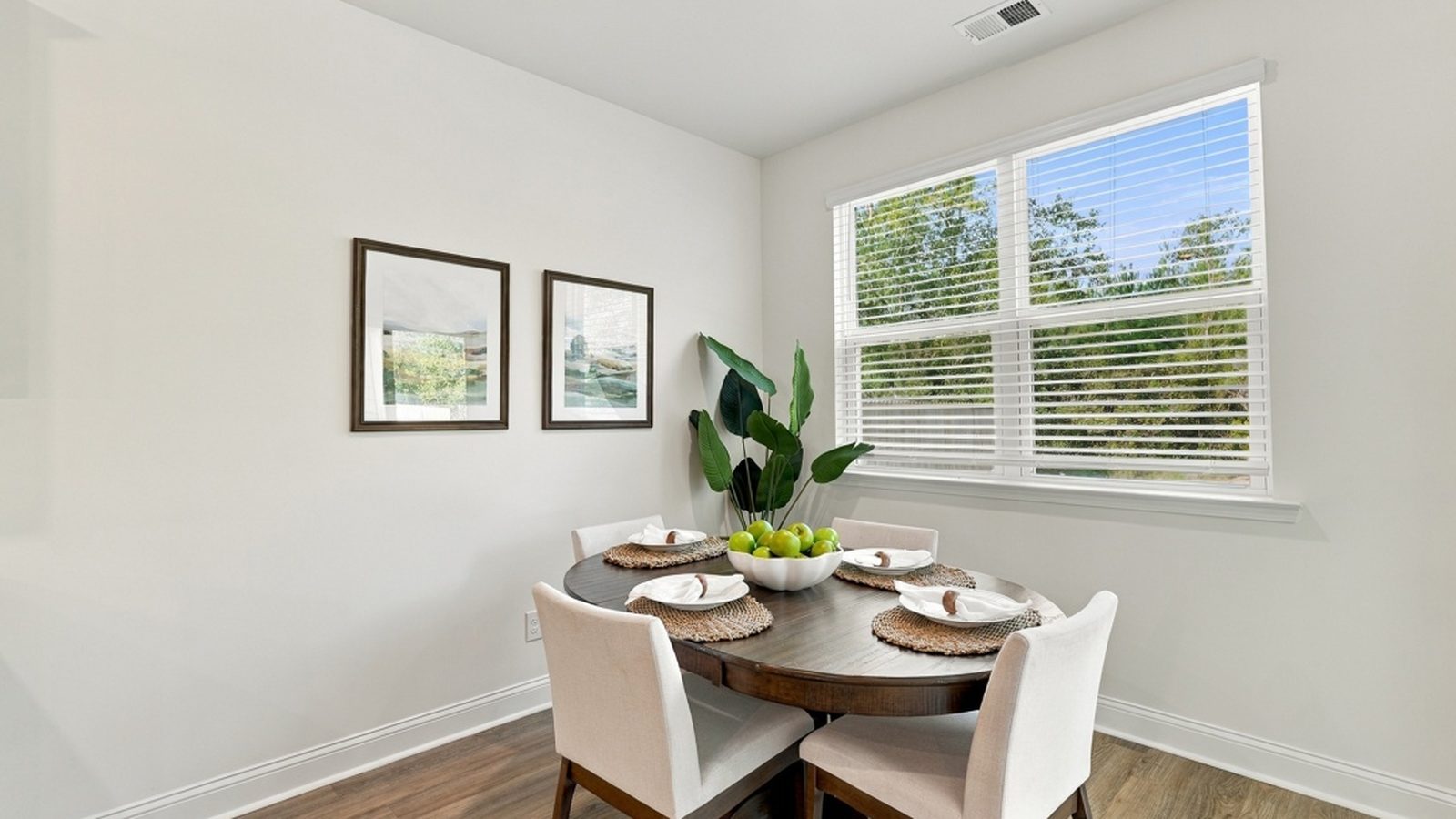 Sunny dining nook adjacent to the kitchen with backyard views and convenient everyday dining space.