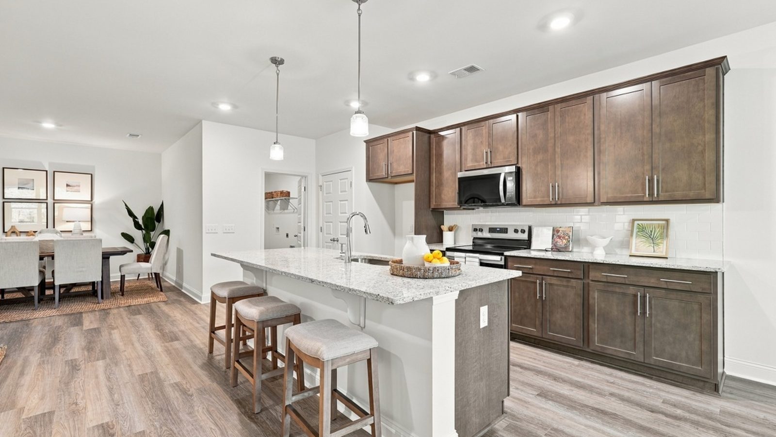 Spacious kitchen featuring a large island, abundant cabinetry, modern appliances, and open sightlines throughout the home.