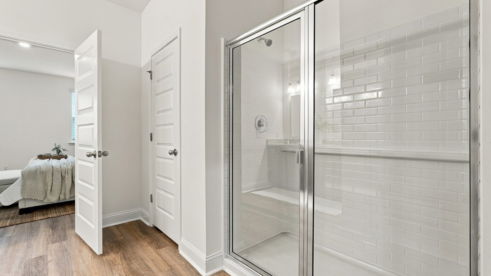 Luxury primary bathroom featuring a walk-in shower and thoughtfully designed layout.