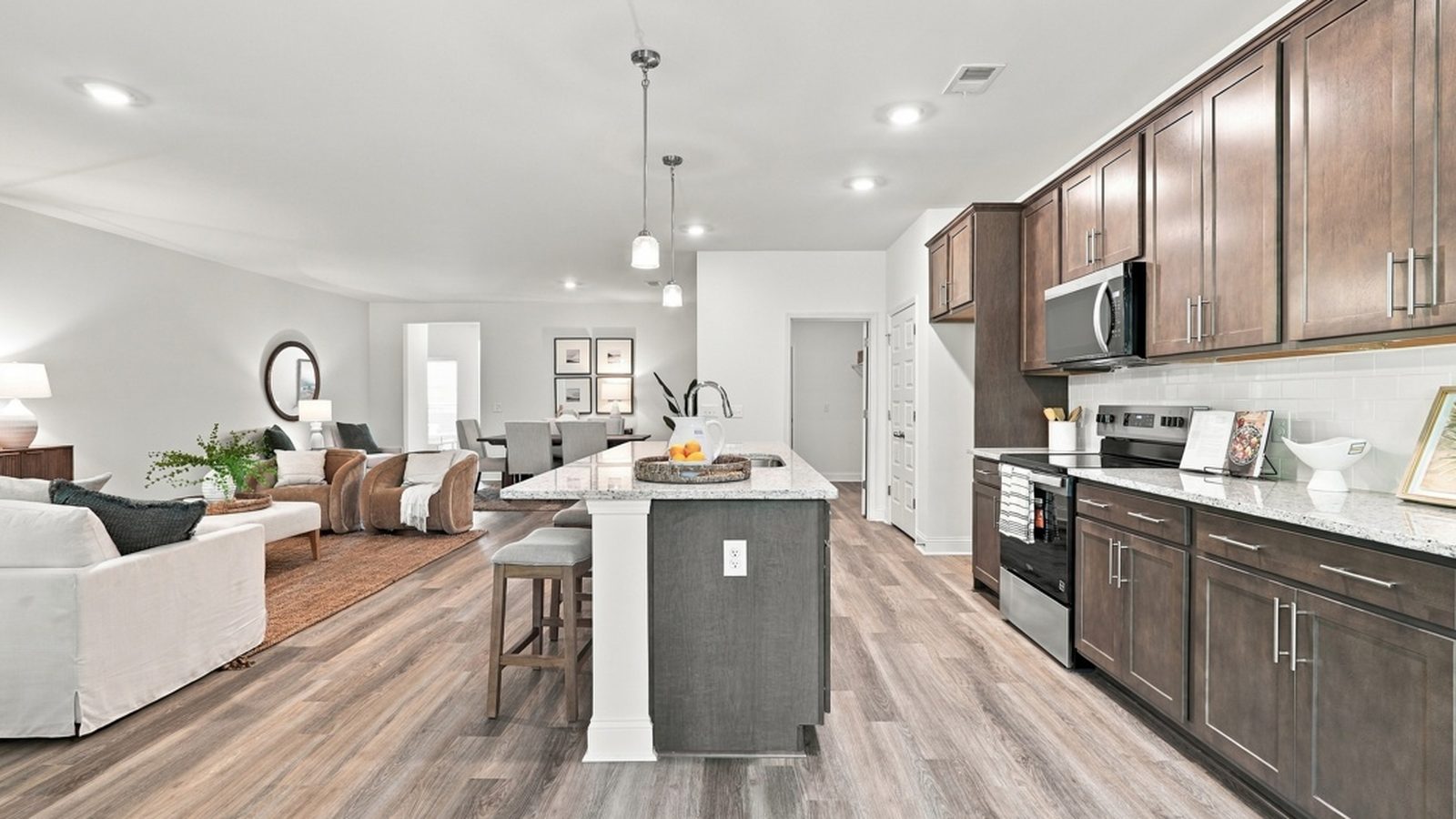 Open-concept kitchen and living room in the Aberdeen E floorplan featuring a large center island, modern finishes, and spacious entertaining areas.